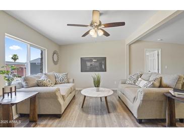 Bright living room with modern ceiling fan and neutral furniture, creating a welcoming atmosphere at 320 E Mckellips Rd # 46, Mesa, AZ 85201