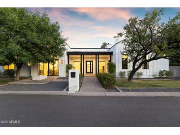 Charming single-Gathering home with manicured lawn and modern architectural details at 3825 E Coolidge St, Phoenix, AZ 85018