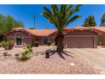 Charming single-story home boasts a desert-landscaped yard, a terracotta tile roof, and attached two-car garage at 5580 W Kesler St, Chandler, AZ 85226