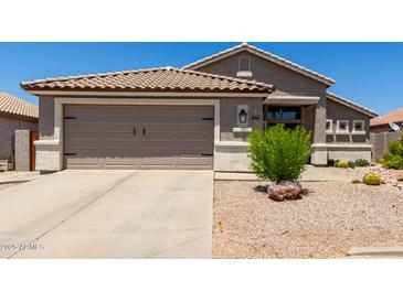 Charming single-story home with a well-manicured front yard and attached two-car garage at 10342 E Obispo Ave, Mesa, AZ 85212