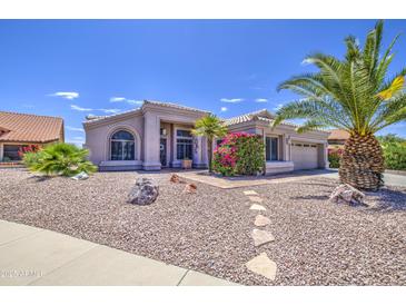 Charming single-story home featuring desert landscaping and a well-manicured yard with mature trees at 14039 S 33Rd Way, Phoenix, AZ 85044