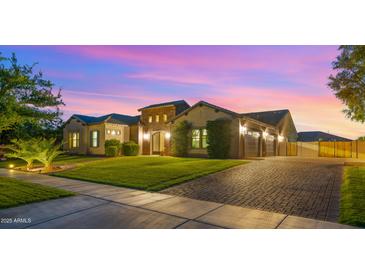 Charming single-story home with manicured lawn and a three-car garage at 17850 E Bronco Ct, Queen Creek, AZ 85142