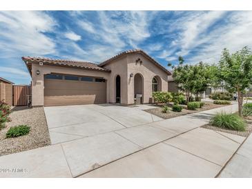 Inviting single-story home boasts a tile roof, a stucco exterior, a two-car garage, and a landscaped front yard at 23068 E Stacey Rd, Queen Creek, AZ 85142