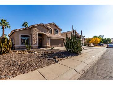 Charming single-Gathering home featuring stone accents, desert landscaping, and an attached two-car garage at 3619 N 104Th Dr, Avondale, AZ 85392