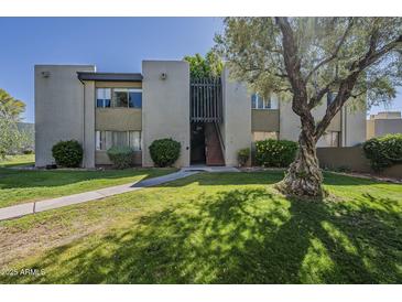 Condo exterior with mature landscaping and well-maintained lawn at 4201 E Camelback Rd # 74, Phoenix, AZ 85018