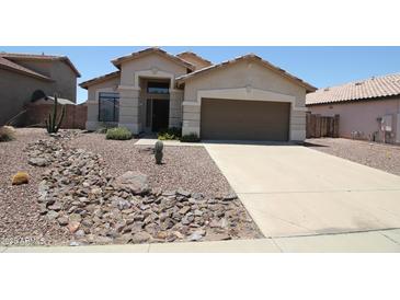 Charming single-story home with a desert landscape, neutral stucco, and a two-car garage at 5437 W Bluefield Ave, Glendale, AZ 85308