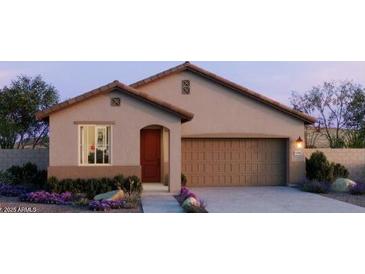 Charming single-story home with a well-manicured front yard and a two-car garage at 5609 S 253Rd Ave, Buckeye, AZ 85326