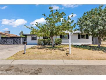 Charming single-story home with a well-maintained front yard and decorative trees under a bright, sunny sky at 7137 N 22Nd Dr, Phoenix, AZ 85021