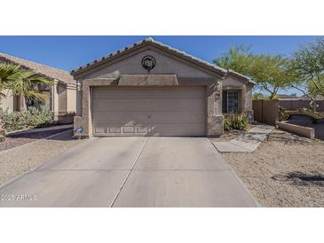 Beige single Gathering home featuring a two-car garage and a well-kept desert-style front yard at 11101 E Abilene Ave, Mesa, AZ 85208