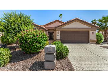 Charming single-story home with manicured landscaping and a two-car garage at 15011 W Verde Ln, Goodyear, AZ 85395