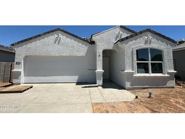 Charming one-story home with a two-car garage and modern stucco exterior at 18340 W Hackamore Dr, Wittmann, AZ 85361