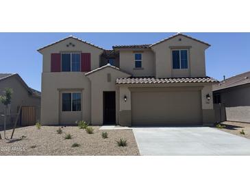 Charming two-story home with a well-maintained front yard and two-car garage, offering curb appeal at 18365 W Villa Hermosa Ln, Surprise, AZ 85387