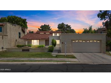 Charming home with a red tile roof, well-maintained lawn, and attached two-car garage at 190 E Tremaine Ave, Gilbert, AZ 85234