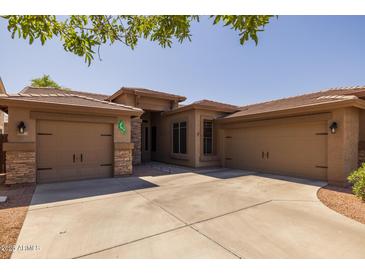 Attractive single-story home featuring a three-car garage and desert landscaping at 2990 N Pearl Ct, Casa Grande, AZ 85122