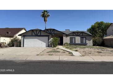 Charming single-story home featuring a two-car garage and a low maintenance front yard landscape at 6407 W Madras Ln, Glendale, AZ 85306