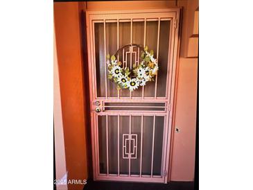 Stylish security door with decorative wreath for welcoming curb appeal at 12212 N Paradise Village S Pkwy # 439, Phoenix, AZ 85032