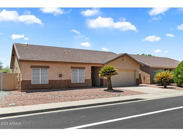Charming single-story home with a well-maintained yard and inviting curb appeal, perfect for comfortable living at 14821 W Honeysuckle Ln, Surprise, AZ 85374