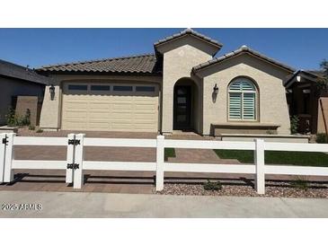 Charming single-story home features desert landscaping and a neutral color palette at 18941 W Monterosa St, Litchfield Park, AZ 85340