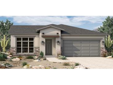 Charming single-story home featuring a desert landscape, stone accents, and a two-car garage at 19317 W San Juan Ave, Litchfield Park, AZ 85340