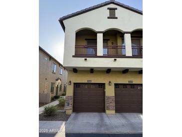 Inviting two-story townhome with a private balcony, beautiful stonework, and two-car garage at 2725 E Mine Creek Rd # 2146, Phoenix, AZ 85024