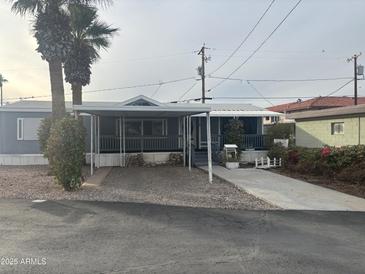 Charming home featuring a covered porch and drought-tolerant landscaping, perfect for low-maintenance living at 5933 E Main St # 1, Mesa, AZ 85206
