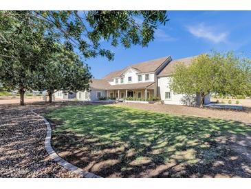 Stunning single-story home featuring a well-manicured lawn and mature trees at 856 W Quail Cir, San Tan Valley, AZ 85143