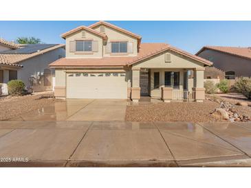 Charming two-story home featuring a neutral-tone facade, a two-car garage, and a well-maintained landscape at 1073 N 159Th Dr, Goodyear, AZ 85338