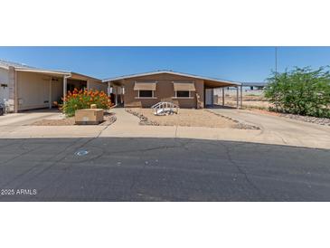 Cozy single story home with awnings and a covered carport is move-in ready at 11275 N 99Th Ave # 1, Peoria, AZ 85345