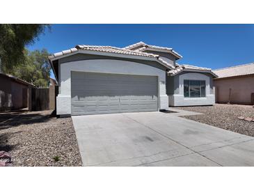 Charming home featuring a two-car garage and neutral gray and white color scheme at 11342 W Barbara Ave, Peoria, AZ 85345