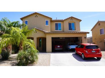 Inviting two-story home featuring a two car garage and manicured lawn at 1309 W Park St, Phoenix, AZ 85041