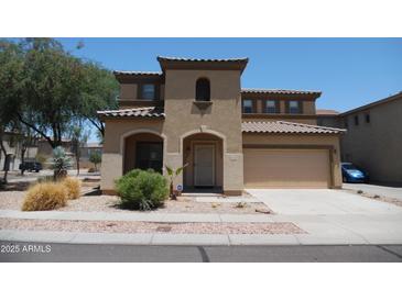 Two-story home featuring a tile roof, a neutral color scheme, and a two-car garage at 18548 W Sunbelt Dr, Surprise, AZ 85374