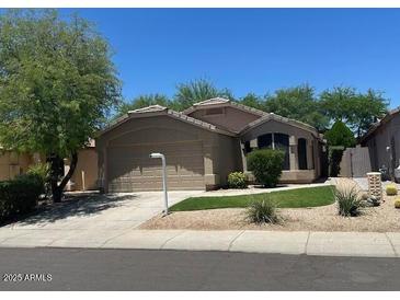 Charming single-story home with a well-maintained lawn and attached two-car garage at 4632 E Melinda Ln, Phoenix, AZ 85050