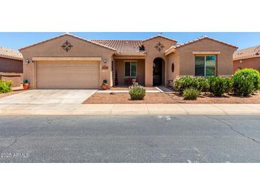 Charming single-story home featuring a two-car garage and well-maintained desert landscaping at 42709 W King Fisher Dr, Maricopa, AZ 85138