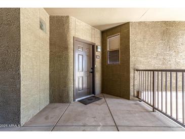 Inviting condo entrance featuring a secure front door and convenient outdoor access at 5303 N 7Th St # 326, Phoenix, AZ 85014