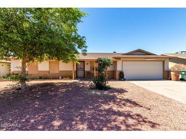 Charming single-story home featuring a low maintenance yard and a two-car garage at 617 E Calle Adobe Ln, Goodyear, AZ 85338