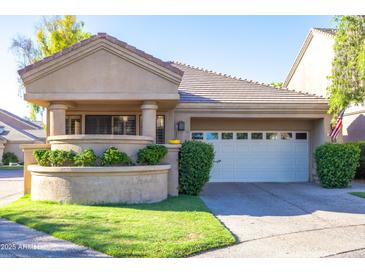 Charming single-story home featuring a front yard with manicured landscaping and a two-car garage at 7525 E Gainey Ranch Rd # 164, Scottsdale, AZ 85258
