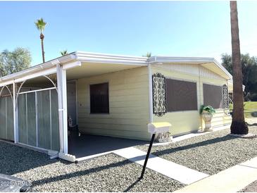 Charming single-story home with a covered entrance and well-maintained gravel landscaping at 120 N Val Vista Dr # 196, Mesa, AZ 85213