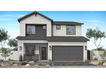 Modern two-story home showcasing a gray facade, a gray two-car garage door and stone accents at 2096 E Mill Rd, San Tan Valley, AZ 85140