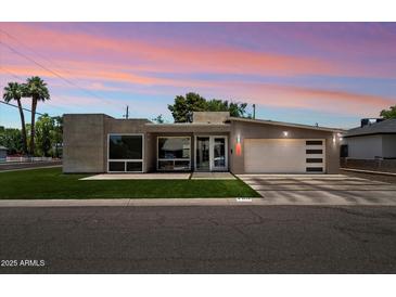 Stunning modern home with unique architectural design, fresh grass, and professional landscaping at 4202 E Catalina Dr, Phoenix, AZ 85018
