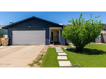 Charming home featuring an attached garage, front yard landscaping, and a welcoming entrance at 5432 W Sunnyside Dr, Glendale, AZ 85304