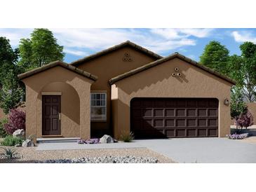 Charming single-story home featuring a two-car garage and low-maintenance desert landscaping at 5822 W Lodge Dr, Laveen, AZ 85339