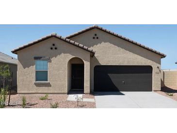 Inviting single-story home featuring a two-car garage, neutral stucco, and a low-maintenance desert landscape at 15517 W Corte Del Sol Este --, Waddell, AZ 85355