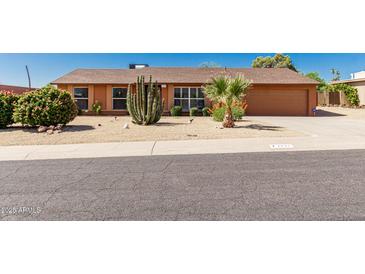 Charming single story home with desert landscaping, including mature cacti and shrubs at 2437 E North Ln, Phoenix, AZ 85028