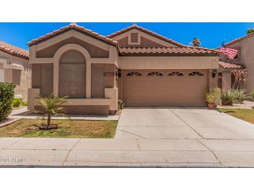 Charming single-story home featuring a two-car garage, desert landscaping and a timeless, neutral color palette at 3440 E Southern Ave # 1088, Mesa, AZ 85204