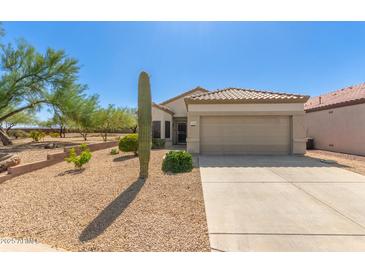 Charming single-story home featuring a desert landscape, tile roof, and a two-car garage in a sunny location at 17108 N Estrella Vista Dr, Surprise, AZ 85374