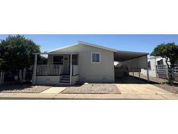 Inviting home featuring covered parking and a charming front porch area at 18026 N Cave Creek Rd # 140, Phoenix, AZ 85032