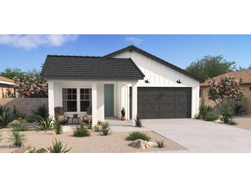 Charming single-story home featuring a modern farmhouse design with a two-car garage and inviting landscaping at 23433 W Burton Ave, Buckeye, AZ 85326