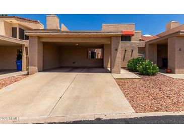 Charming townhouse with a covered carport and easy to maintain desert landscaping at 26 E Coral Gables Dr, Phoenix, AZ 85022