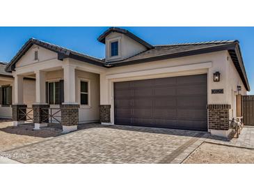 Home exterior features a two-car garage, a well-maintained lawn and professional landscaping at 3629 E Rochelle Cir, Mesa, AZ 85213