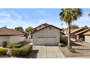 Charming single-Gathering home with a two-car garage, mature landscaping, and a beautiful palm tree in the front yard at 4182 W Park Ave, Chandler, AZ 85226